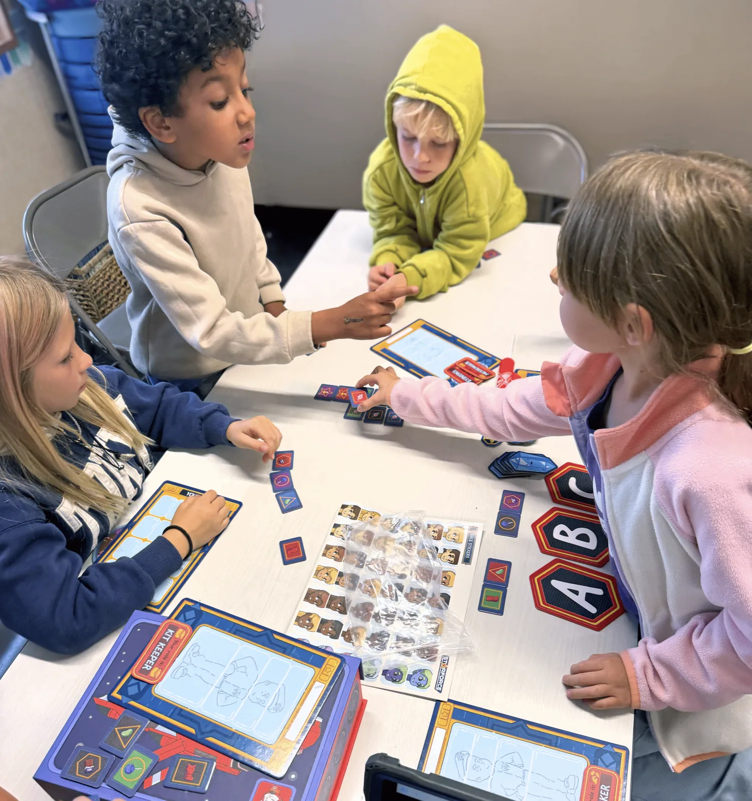 Young students gathered around a table working through a Starforce mission together